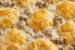 Sausage, Rich Gravy, and Biscuit Pie with golden biscuits baked over creamy sausage gravy