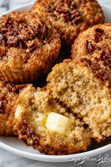 Keto cinnamon pecan cottage cheese muffins topped with chopped pecans