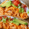 High protein cheesy buffalo chicken tortilla wrap with shredded chicken, melted cheese, and buffalo sauce