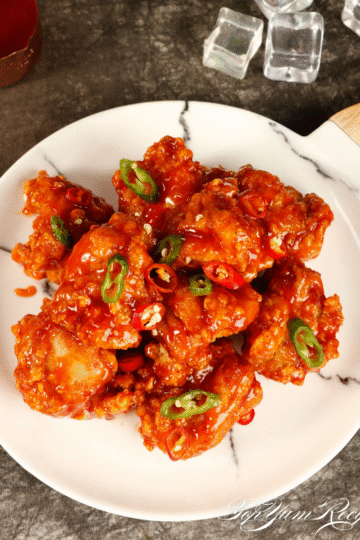 Alt text: "Close-up of crispy Korean fried chicken wings with a glossy, golden double-fried crust