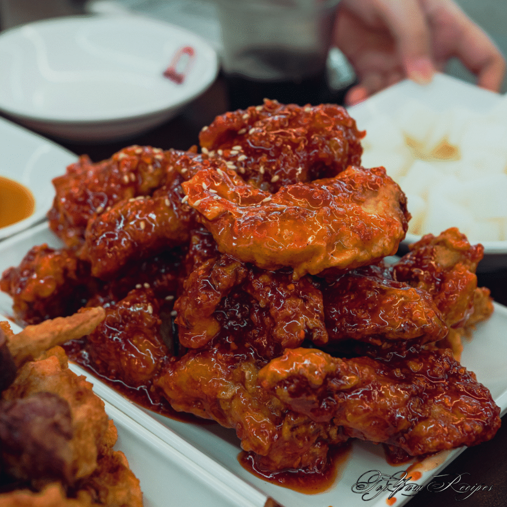 Alt text: "Close-up of crispy Korean fried chicken wings with a glossy, golden double-fried crust